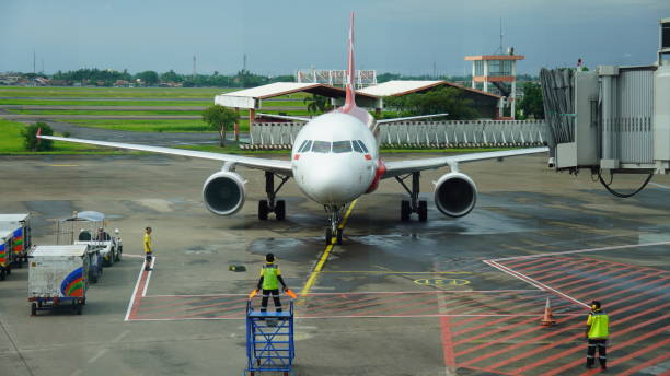 AirAsia crew at Soekarno-Hatta Airport Indonesia, January 14, 2024
The skilled AirAsia airplane parking attendant at Soekarno-Hatta Airport is vital for smooth and secure ground operations. It is important to check the local airline stock pictures, royalty-free photos & images