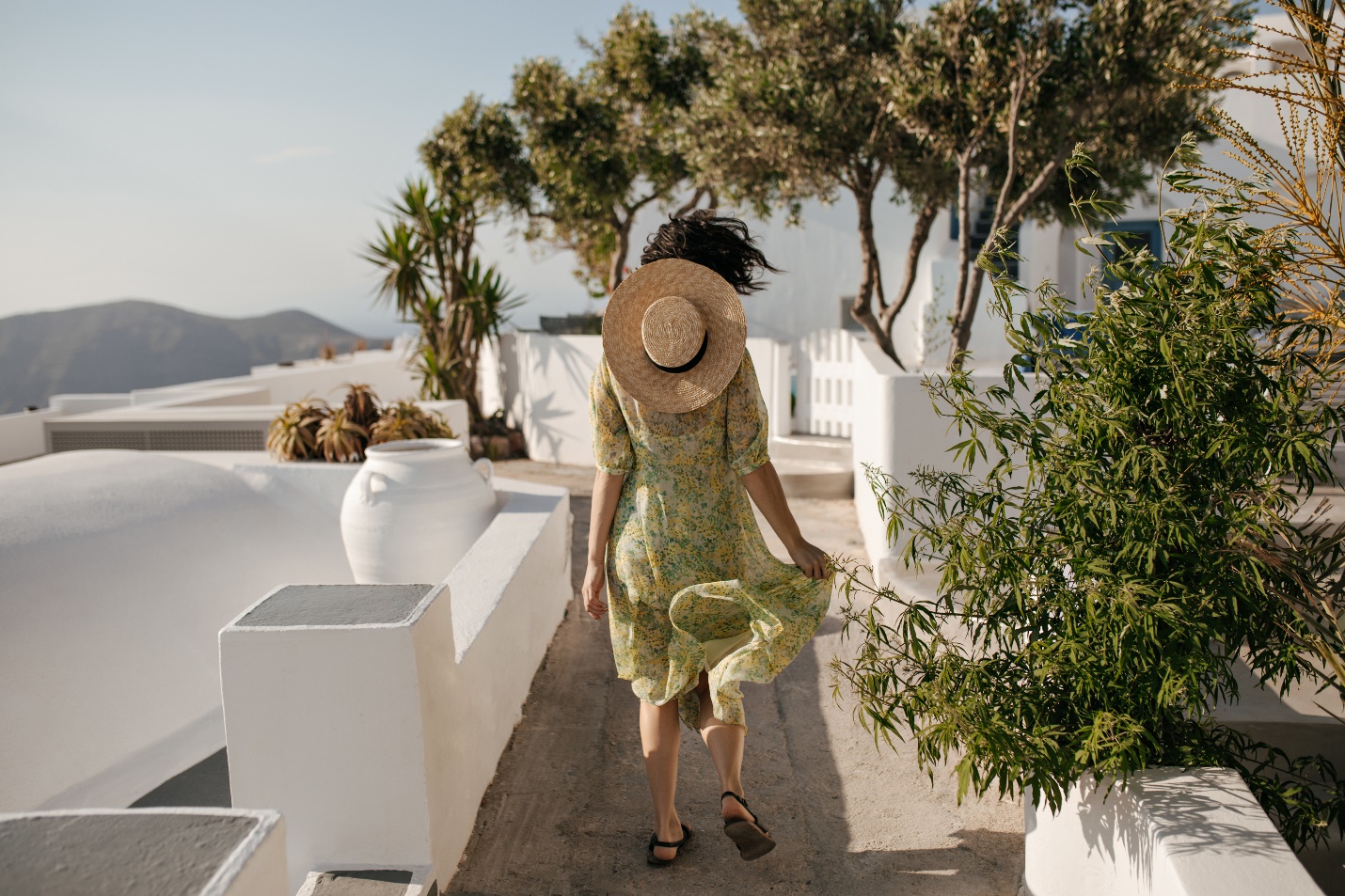 C:\Users\Mafia\Downloads\curly-short-haired-woman-floral-dress-boater-runs-outside.jpg