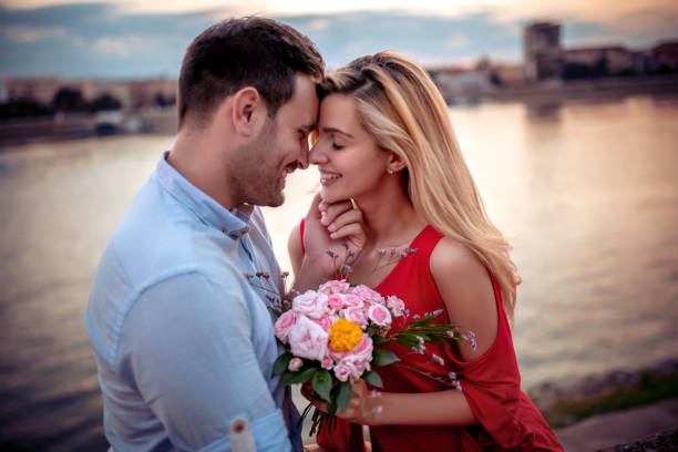 Couple in love enjoying together Portrait of a happy young couple enjoying in sunset. Romantic Ways for Couples in 2025 stock pictures, royalty-free photos & images