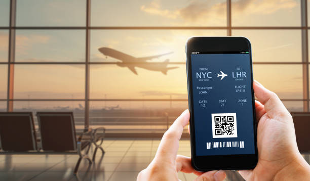 electronic boarding pass,plane ticket travel concept. Man hands showing electronic boarding pass,plane ticket on blurred airport as background Use travel apps stock pictures, royalty-free photos & images