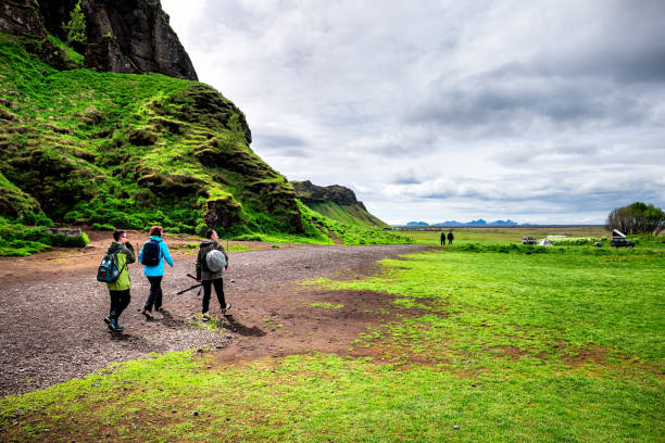Gljufrabui waterfall area with landscape and camping tents with people on trail hiking in Iceland Seljalandsfoss, Iceland - June 14, 2018: Gljufrabui waterfall area with green summer landscape and camping tents with people on trail hiking Ring Road Tour of Iceland stock pictures, royalty-free photos & images