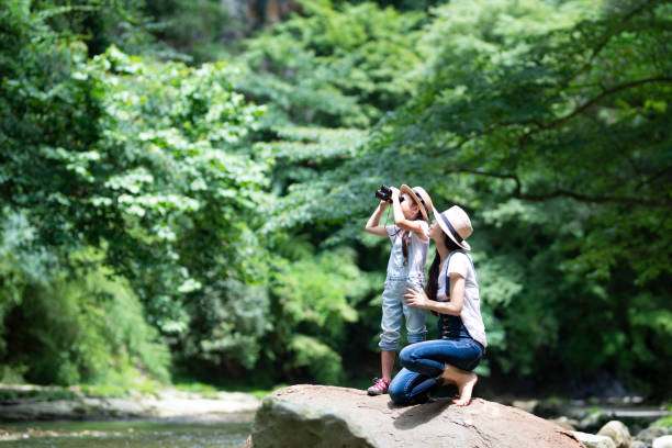 Mother and daughter playing in the river Mother and daughter playing in the river Joy of Photo & Exploration stock pictures, royalty-free photos & images