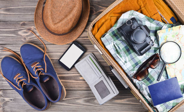 Open suitcase for travel with things and accessories Open suitcase for travel with things and accessories Packing Tips for Light and Smart Travel stock pictures, royalty-free photos & images