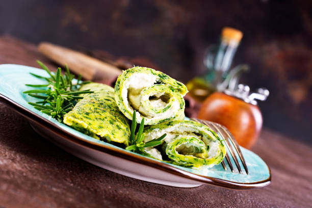 Rolls of spinach pancakes with cheese and shrimps Rolls of spinach pancakes with cheese and fried shrimps Try salads and vegetables stock pictures, royalty-free photos & images