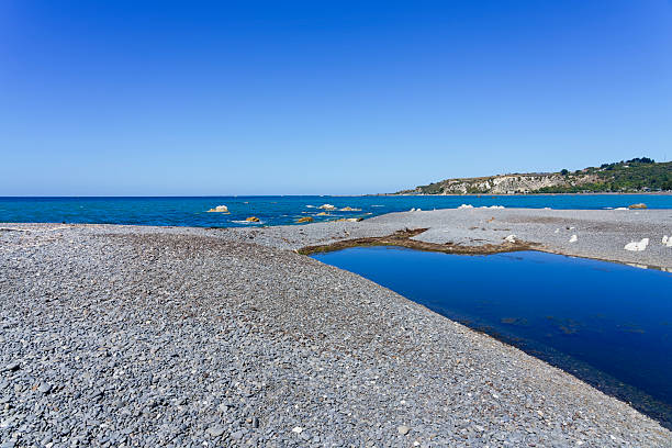 Shallow lagoon on Kaikoura beach, New Zealand. A shallow lagoon on Kaikoura beach on a cloudless summer afternoon. Coastal Pacific Unused Zealand stock pictures, royalty-free photos & images