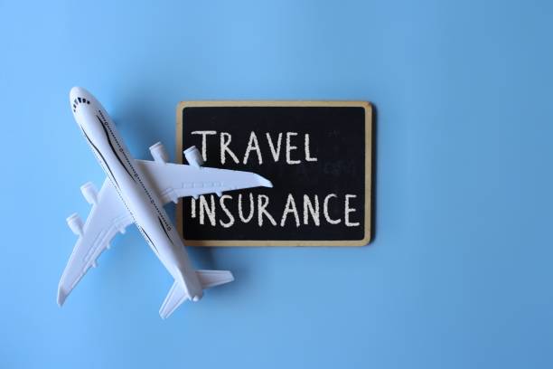 Top view image of toy plane and chalkboard with text TRAVEL INSURANCE Top view image of toy plane and chalkboard with text TRAVEL INSURANCE on blue background. Travel insurance wisely stock pictures, royalty-free photos & images