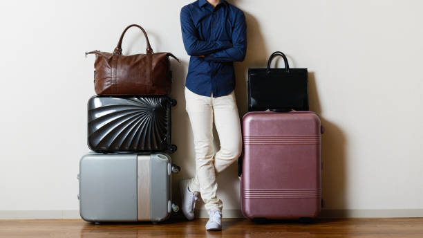 Travel bag and man Travel bag and man in the room Choosing the right bag Smart Travel stock pictures, royalty-free photos & images