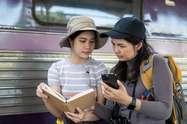 Woman using mobile phone while travel by train. travel concept Woman using mobile phone while travel by train. travel concept. Finding local vocabulary is helpful during travel stock pictures, royalty-free photos & images